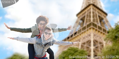 Image of happy teenage couple over paris eiffel tower