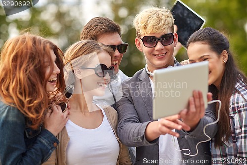 Image of students or teenagers with tablet pc taking selfie