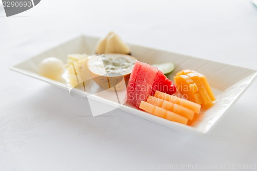 Image of plate of fresh juicy fruit dessert at restaurant