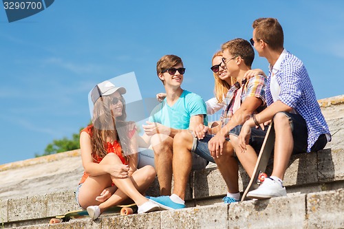 Image of group of smiling friends sitting on city street