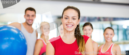 Image of woman standing in front of the group in gym