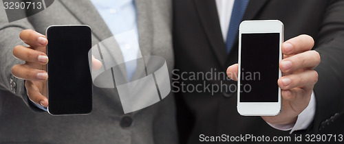 Image of businessman and businesswoman with smartphones