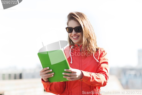 Image of happy young woman or teenage girl with tablet pc