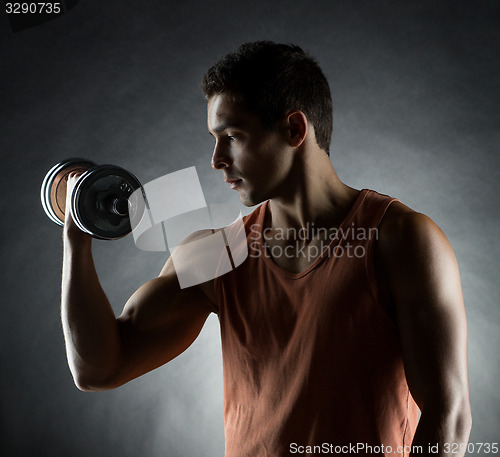 Image of young man with dumbbell