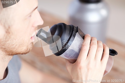 Image of close up of man drinking protein shake