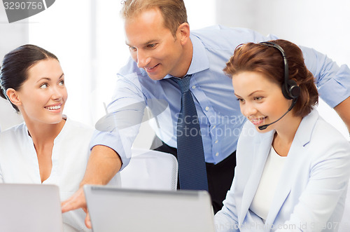 Image of group of people working in call center