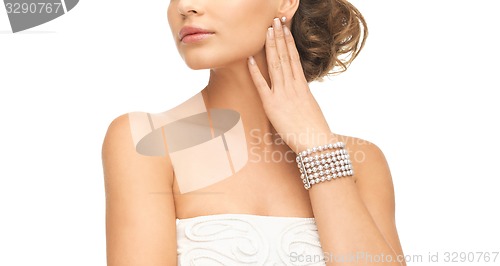 Image of woman with pearl earrings and bracelet