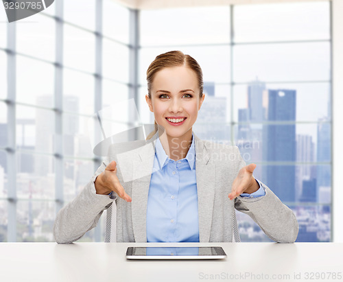 Image of smiling businesswoman with tablet pc 