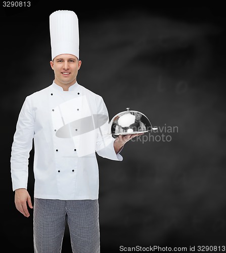 Image of happy male chef cook holding cloche