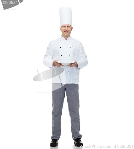 Image of happy male chef cook showing empty plate