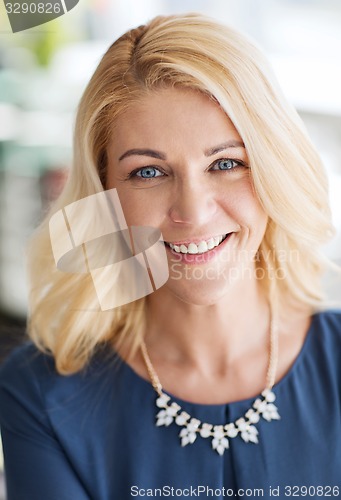 Image of happy smiling blonde woman in blue clothes