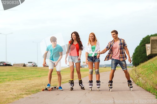 Image of group of smiling teenagers with roller-skates