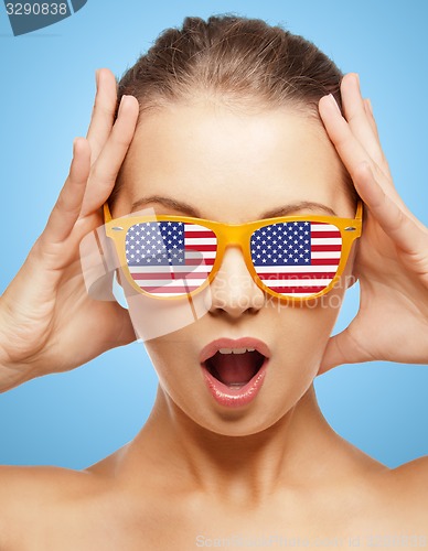 Image of happy teenage girl in shades with american flag