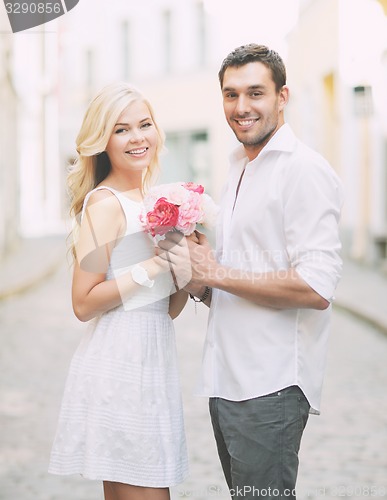 Image of couple with flowers in the city