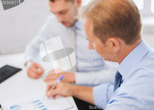 Image of businessmen with notebook on meeting