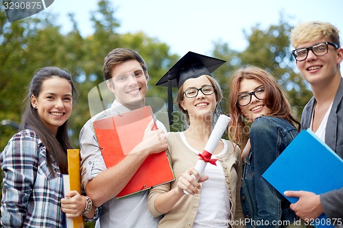 Image of group of smiling students with diploma and folders