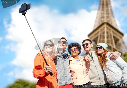 Image of smiling friends taking selfie with smartphone