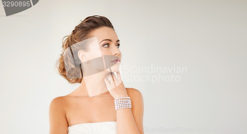 Image of woman with pearl earrings and bracelet