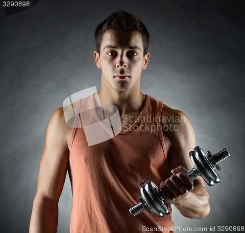 Image of young man with dumbbell