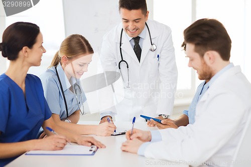 Image of group of happy doctors meeting at hospital office