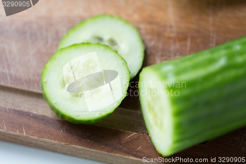 Image of close up of cucumber on wooden cutting board