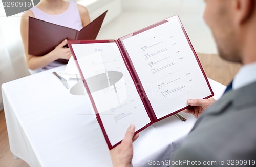 Image of close up of couple with menu at restaurant