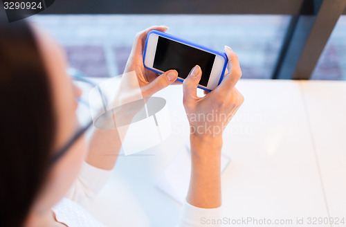 Image of close up of woman with smartphone at office