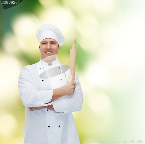Image of happy male chef cook holding rolling pin