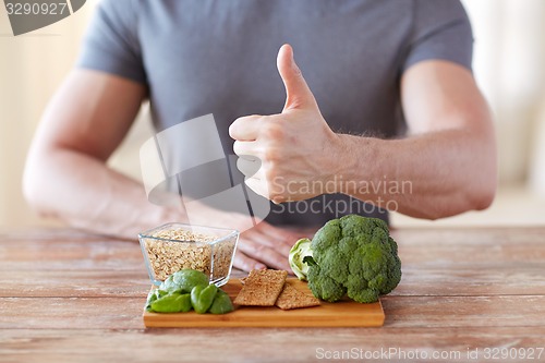 Image of close up of male hands showing food rich in fiber