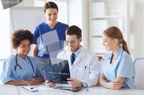 Image of group of happy doctors discussing x-ray image