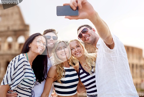 Image of friends taking selfie with smartphone