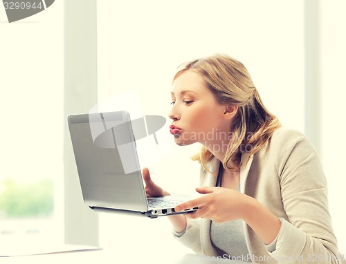 Image of woman sending kisses with laptop computer