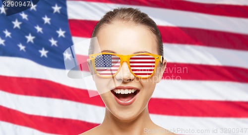 Image of happy teenage girl in shades with american flag