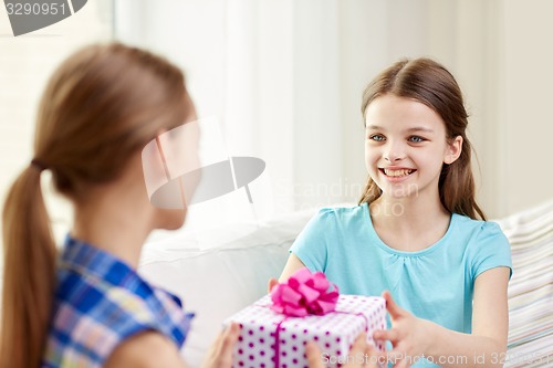 Image of happy little girls with birthday present at home