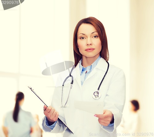 Image of calm female doctor with clipboard