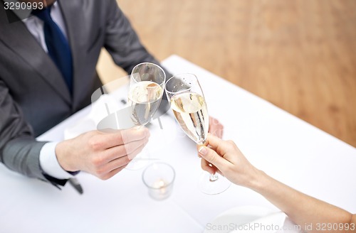 Image of couple with glasses of champagne at restaurant