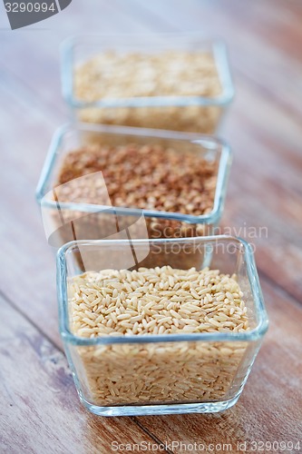 Image of close up of grain in glass bowls on wooden table