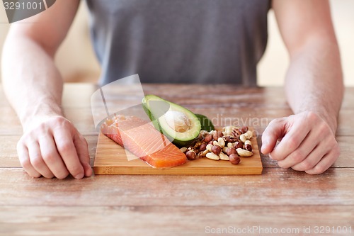 Image of close up of male hands with food rich in protein