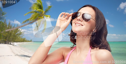 Image of happy woman in sunglasses and swimsuit