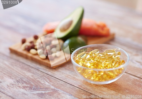 Image of close up of omega 3 capsules and food on table