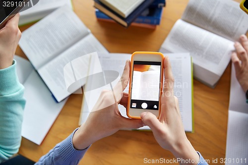 Image of students with smartphones making cheat sheets