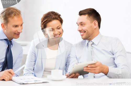 Image of business team having fun with tablet pc in office