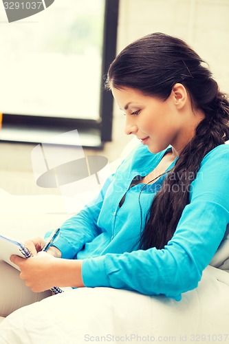 Image of calm woman with big notepad