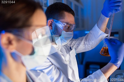 Image of close up of scientists making test in lab