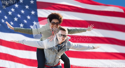 Image of happy multiracial couple over american flag