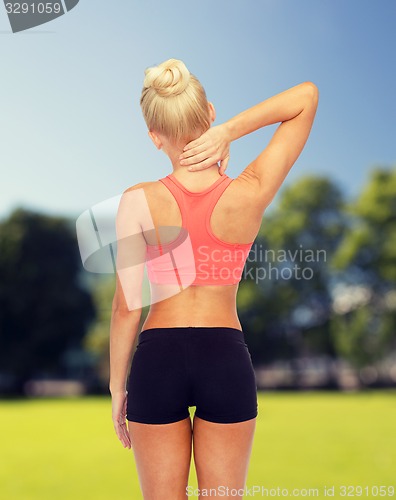 Image of sporty woman touching her neck