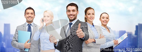 Image of group of smiling businessmen showing thumbs up