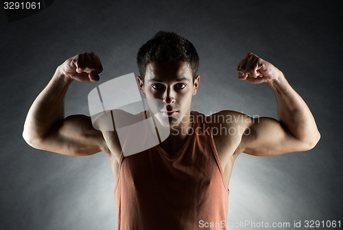 Image of young man showing biceps