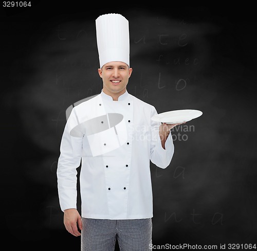 Image of happy male chef cook showing empty plate