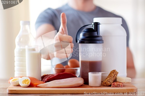 Image of man with protein food showing thumbs up